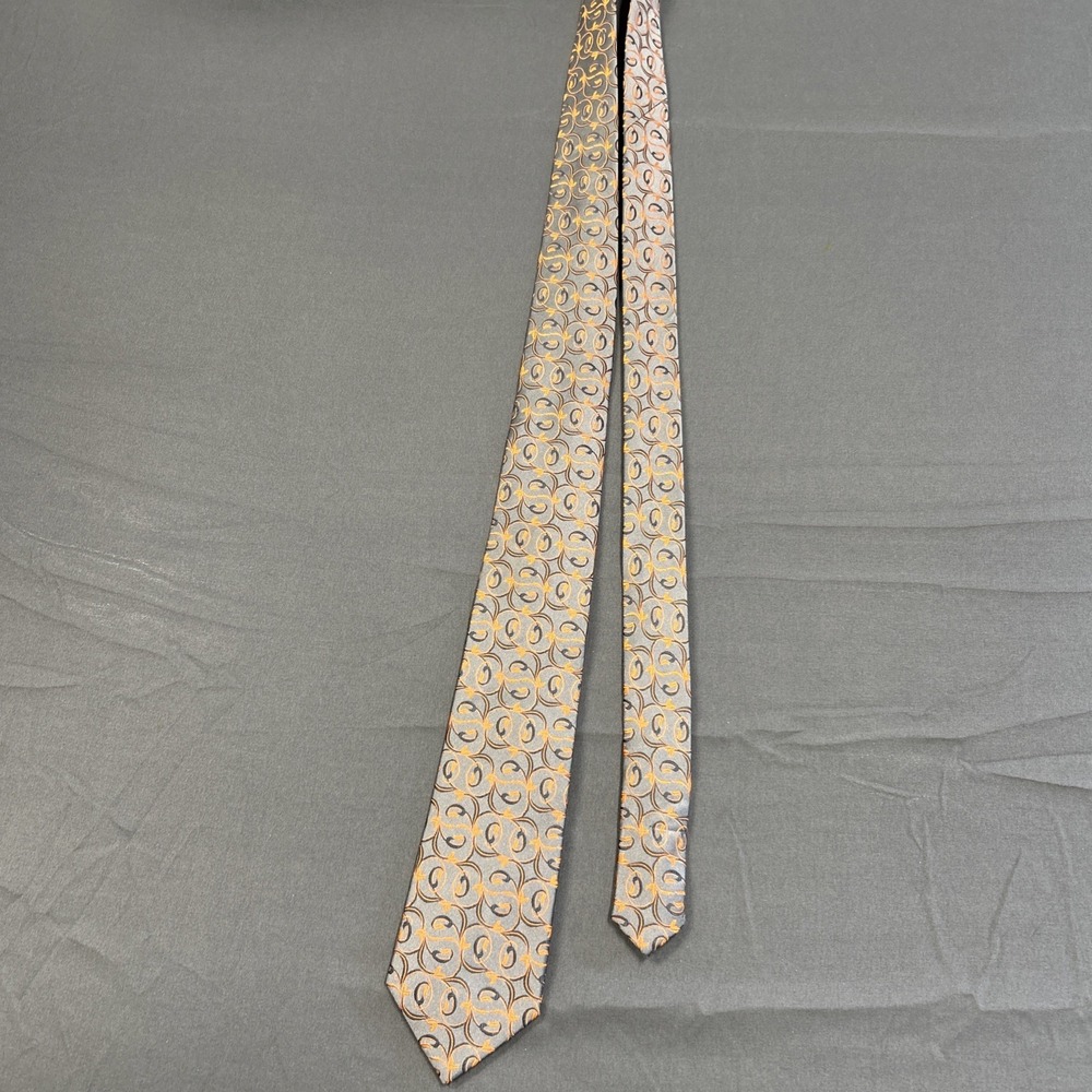 Aleani tie features a light blue silk base with a repeating orange